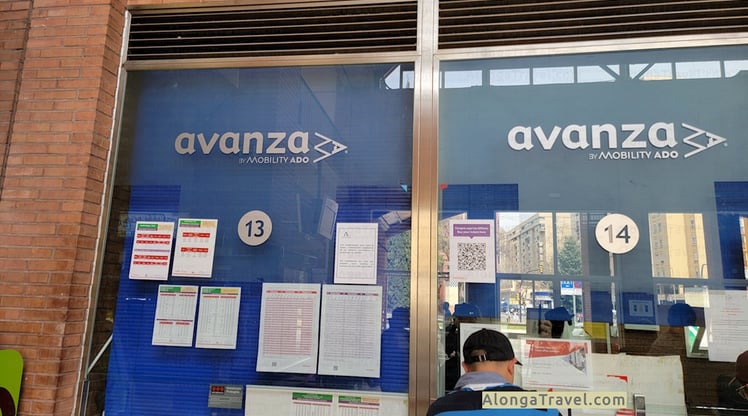 A person in front of me is buying a bus ticket at Avanza mobility Ado ticket booth