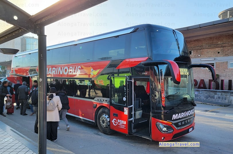 I'm watching people to board into a red double-decker Marinobus in Italy