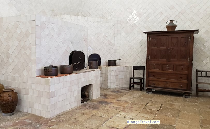 Ovens and stove with cooper pots on them in a kitchen in Sintra National Palace interior