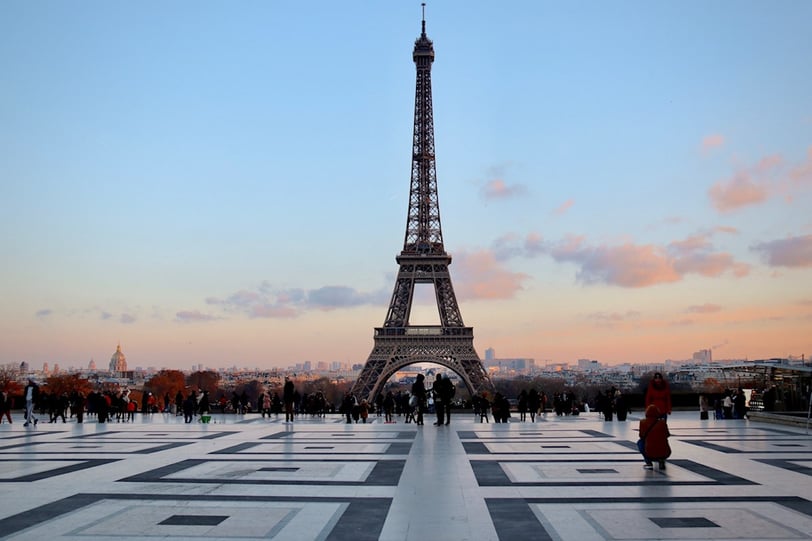 Eiffel Tower hovers over skyline of Paris, a place to fly cheaply into in Europe