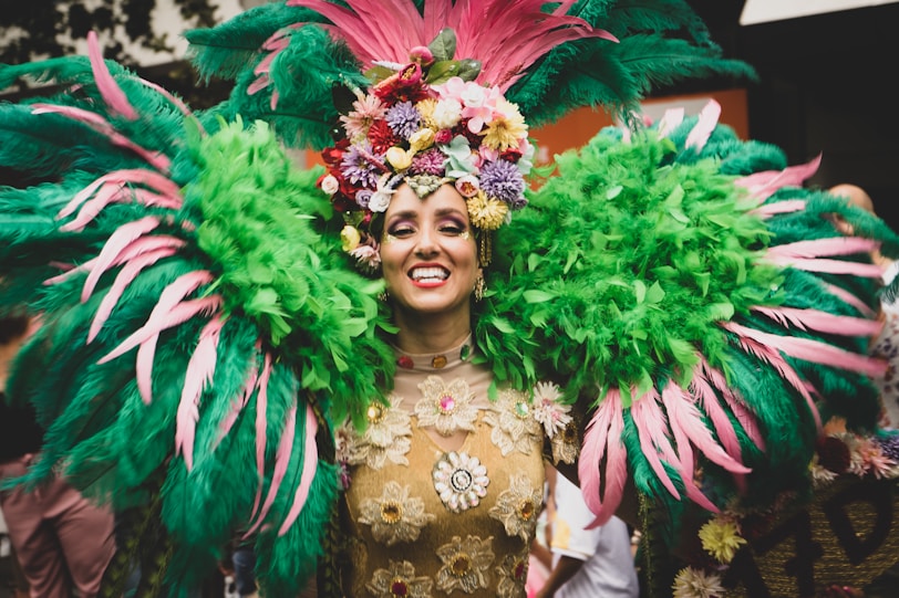 a woman in a green and pink carnival costume
